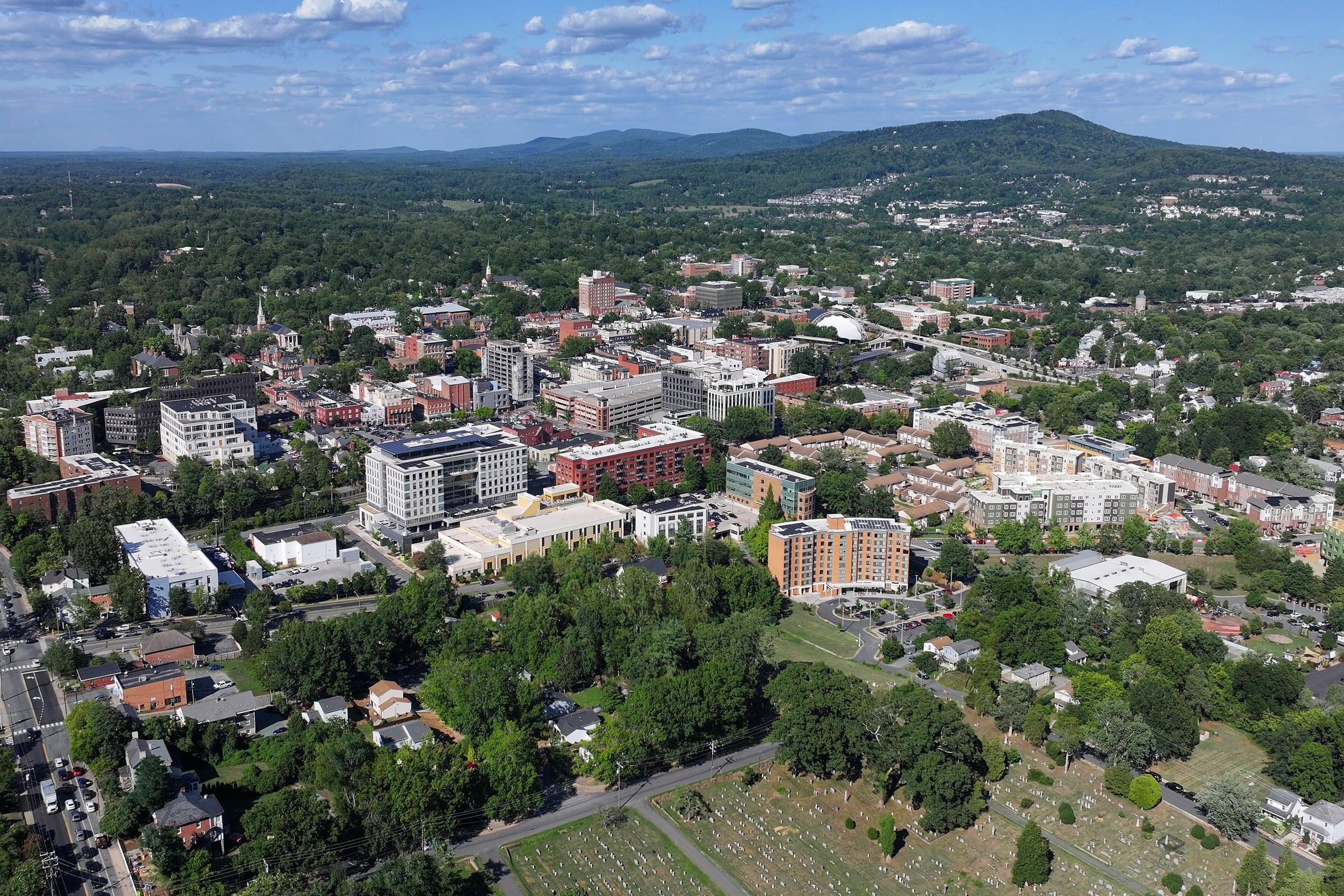 Aerial view of downtown Charlottesville surrounded by green hills