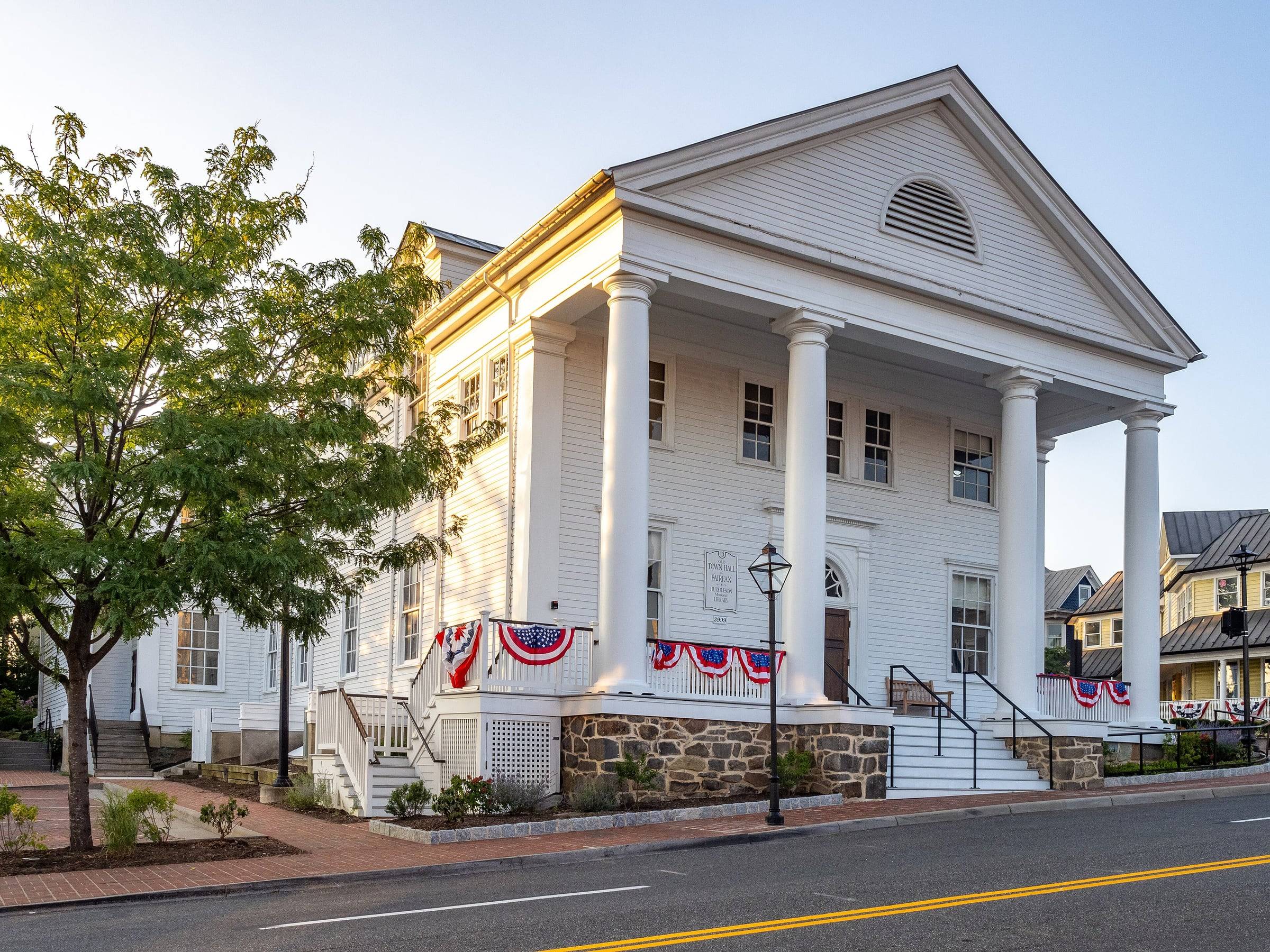 The white-columned Old Town Hall in the City of Fairfax, decorated with red, white and blue bunting